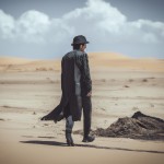 یک مرد  اسرارآمیز با شنل چشمگیر که در صحرا قدم می زند