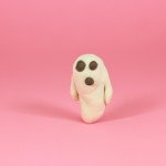 A cute ghost made of clay on a pink background