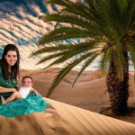 تصویر نوزاد تازه متولد شده در بیابان و مادری که زیر درخت نخل نشسته