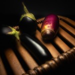 تصویر یک بادمجان ناراحت و در بستر مرگ در حالی که بقیه میوه ها کنار او نشسته اند و ناراحت هستند